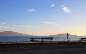 A woman running along the bay