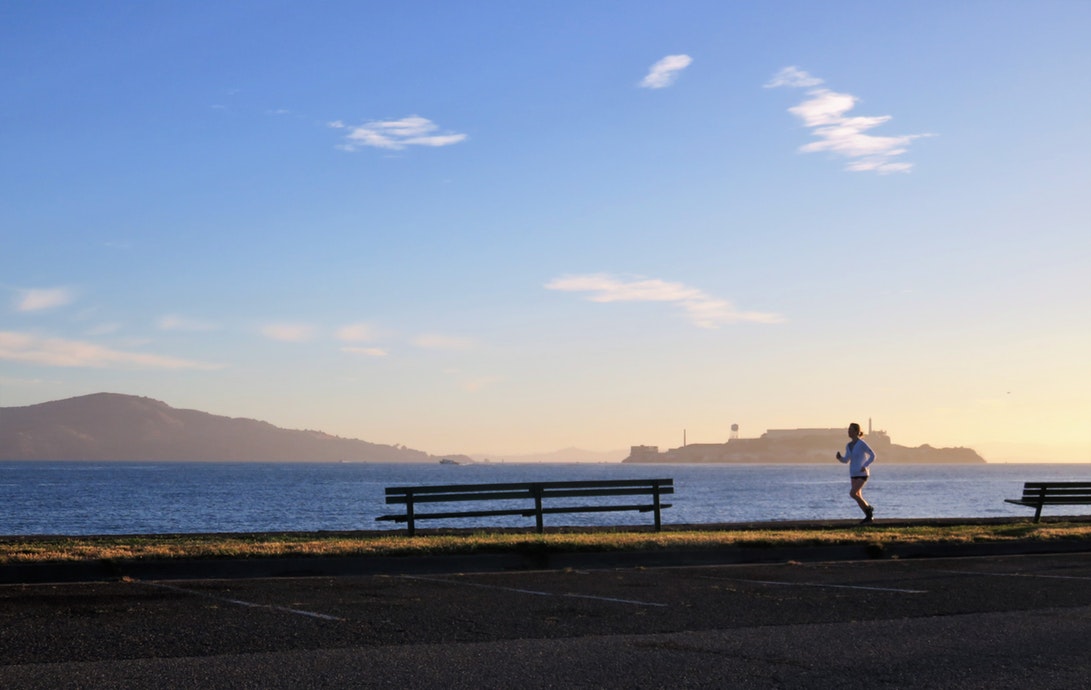 A person running along the San Fransisco Bay.